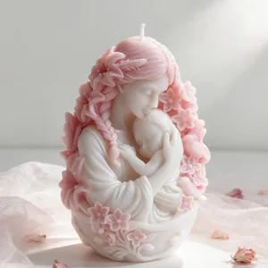 Macro detail of artistic mother and baby candle with delicate pink flower accents