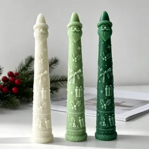 Detailed view of three Santa Claus tapered candles in cream and shades of green colors.