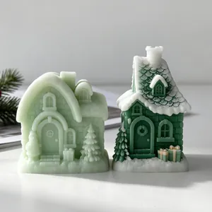 Detail view of green snow house candles with intricate roof and window textures