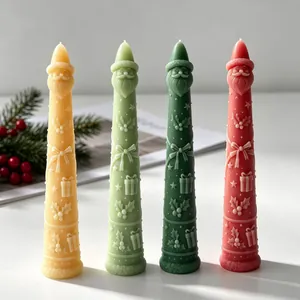 Detailed view of four colorful Santa Claus taper candles for Christmas decoration