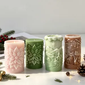 Detailed view of four Christmas relief candles with floral and forest animal carvings.