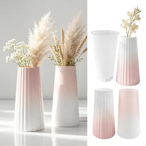 Detail view showing vertical striped silicone mold and finished pink gradient plaster vases