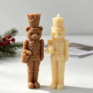 Macro view of handmade bear and cat nutcracker soldier candles with Christmas decor