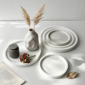 Artistic lifestyle arrangement of white and grey handmade round plaster storage trays