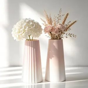 Elegant pink gradient ceramic-like vases with artificial flowers for modern home decor