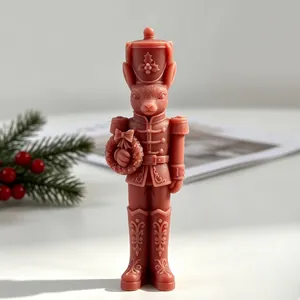 Detailed view of a pink rabbit nutcracker soldier candle with Christmas decorations