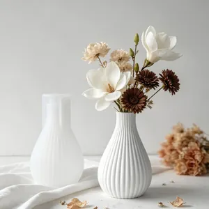 Close-up view of striped silicone vase mold featuring elegant white floral arrangement