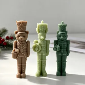 Set of three nutcracker animal candles: bear, rabbit, and cat in holiday uniforms.