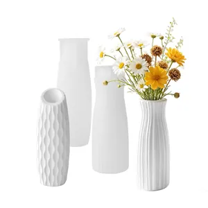 Detail view of various textured white silicone molds for DIY plaster flower vases.