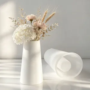 White silicone mold for DIY plaster vase shown with finished product and elegant dried flowers