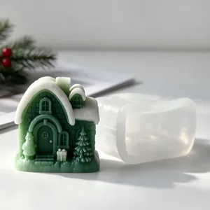 Detailed view of a green Christmas snow house candle and its translucent silicone DIY mold