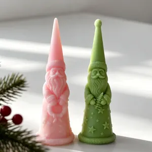 Detailed close-up of pink and green Santa Claus candles with star patterns