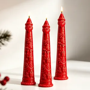 Three red Santa Claus taper candles featuring detailed embossed Christmas patterns