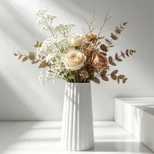 Detail of a minimalist white ribbed fluted gypsum vase with dry flower arrangement