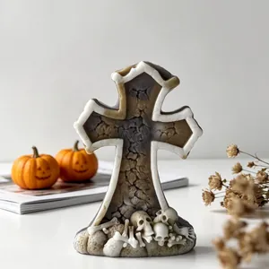 Detailed view of Gothic Halloween cross gravestone candle with skull and bones decor
