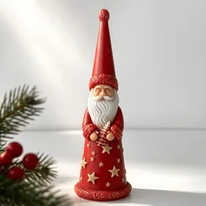 Detailed view of a Santa Claus shaped candle featuring star patterns and a pine tree