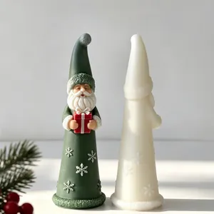 Detailed view of two Santa Claus scented candles featuring snowflake relief patterns.