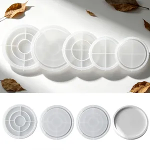 Detail view of various circular silicone molds for DIY resin coasters and tray projects.