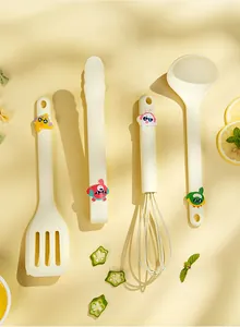 Detail view of mini cream silicone spatula, whisk, and ladle set with cartoon characters
