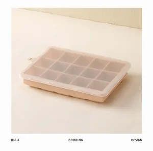 Detailed view of a peach silicone ice cube tray with 15 compartments and a clear lid.