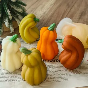 Close-up of vibrant DIY pumpkin candles next to a translucent silicone molding tool