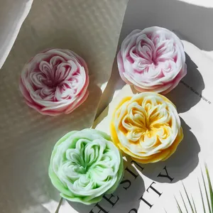Macro detail showing four colorful rose-shaped candles made with silicone molds