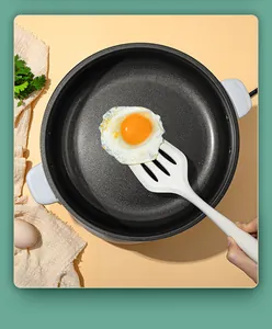 High-quality white silicone slotted turner lifting a fried egg in a non-stick pan