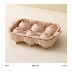 Detailed view of a 6-cavity beige silicone sphere ice mold for chilled whiskey drinks