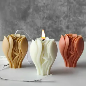 Detailed macro view of elegant textured rose flower candles in beige, white, and pink.