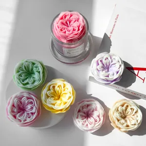 Detailed view of colorful rose-shaped candles with natural sunlight and shadow effects