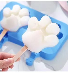 Detailed view of a white cat paw-shaped popsicle made using a blue silicone mold
