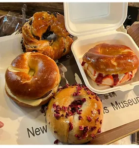 Assorted freshly baked donuts with chocolate and strawberry toppings on a white tray