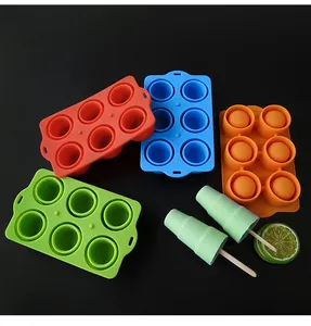 Close-up of 6-cavity colorful silicone popsicle molds with finished ice pops on black background