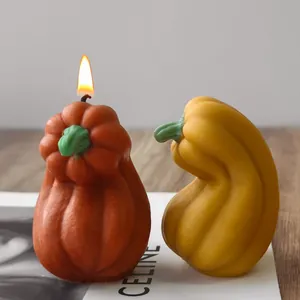 Detailed view of handmade pumpkin-shaped scented candles for Halloween decor