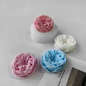 Detail of 3D rose flower silicone mold with finished pink, blue and white candles
