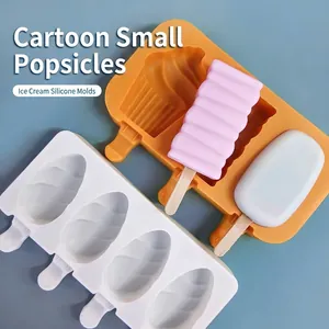 DIY silicone ice pop molds in white and orange with wooden sticks for home popsicle making