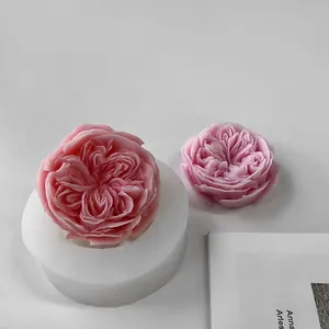 Detailed view of realistic rose-shaped aromatherapy candles and DIY white silicone mold