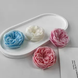 Detailed view of rose-shaped candles in various colors showing petal textures