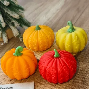 Detailed view of decorative Halloween pumpkins with intricate embossed patterns in warm tones.