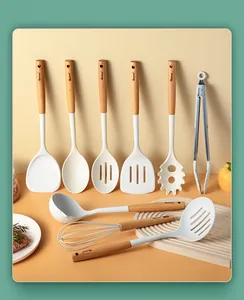 Comprehensive set of silicone kitchen utensils with ergonomic beech wood handles.