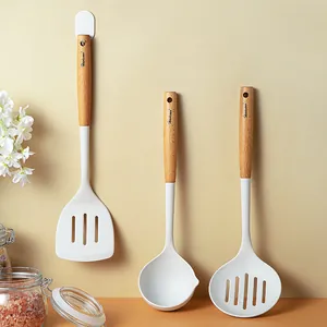 Three-piece white silicone kitchen utensil set with ergonomic beechwood handles