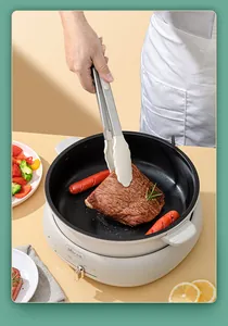 Professional heat-resistant silicone food tongs flipping juicy steak in a frying pan