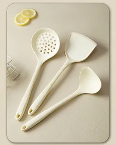 Cream-colored silicone kitchen utensil set featuring a spatula, ladle, and skimmer.
