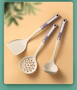 Detail view of silicone kitchen utensil set with spatula, ladle, and slotted spoon