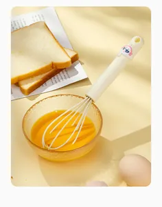 Detailed view of cream mini silicone whisk with cute cartoon rabbit handle decoration