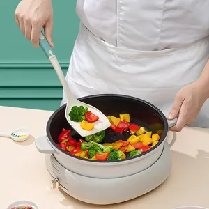 Heat-resistant cream silicone spatula for non-stick pans shown in a cooking scene
