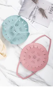 Detail view of blue and pink silicone steamer inserts for steaming buns and vegetables