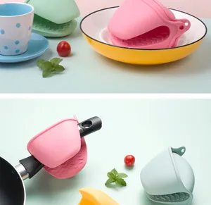 Detailed view of colorful heat resistant silicone oven mitts in a kitchen setting