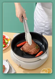 Professional heat-resistant silicone kitchen tongs used for flipping steak in a pan