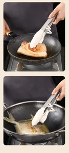 Action shot of silicone food tongs with stand flipping steak and fish in pans